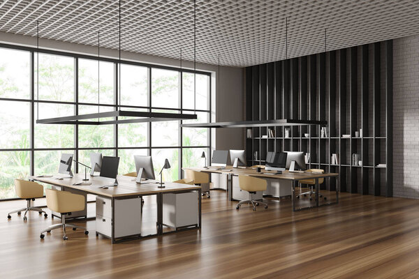 Corner of stylish open space office with white and white brick walls, wooden floor, rows of computer tables with yellow chairs and panoramic window with tropical view. 3d rendering