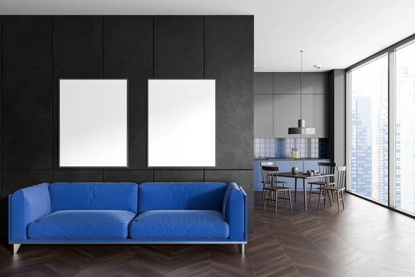 Grey and blue home studio interior with sofa and kitchen with dinner table. Lounge zone with two mock up canvas posters in row. Panoramic window on skyscrapers. 3D rendering