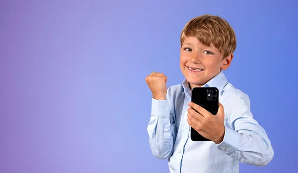 Portrait Happy Celebrating Boy Smartphone Standing Purple Background Concept Victory — Stock Photo, Image