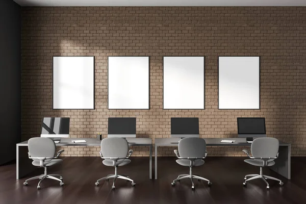 Dark brown brick coworking interior with shared desk and pc computer in row. Business office room with minimalist furniture and four mock up canvas posters in row. 3D rendering