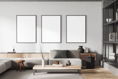 Beyaz oturma odasındaki kanepe, halının üzerindeki kahve masası, ahşap zeminde modern sanat süslemeleri olan şifonyer. Üç tane çadır bezi afişi. 3B görüntüleme