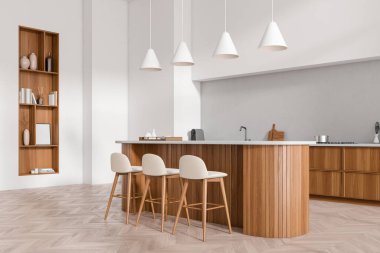 Parlak mutfak manzarası. İçi ada ve bar tabureleriyle dolu.