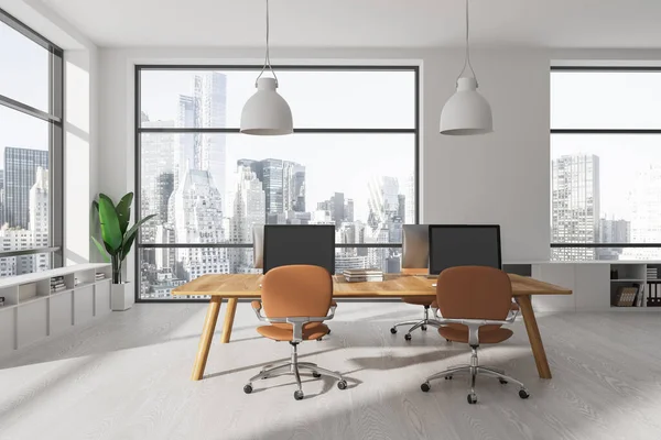 stock image Stylish workplace in modern New York open space office with white walls, wooden floor and computer table with brown chairs. 3d rendering