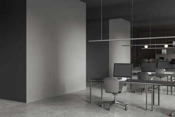现代开放空间办公室的拐角处 有灰色墙壁 混凝土地面 一排有灰色椅子的计算机桌子和左边的模拟墙 3D渲染 — 图库照片
