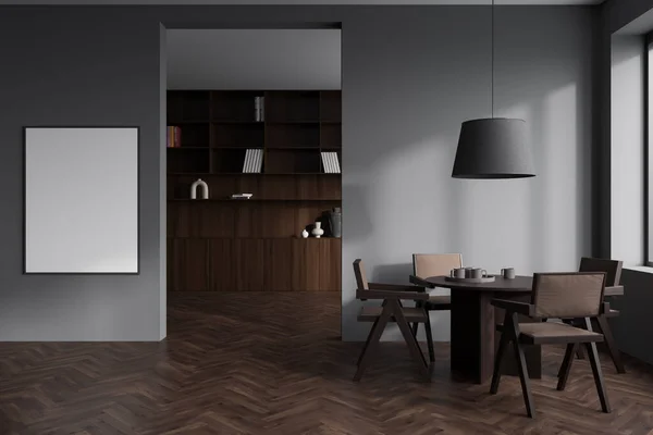 Front view on dark living room interior with empty white poster, dining table with chairs, grey wall, cupboard with books, wooden hardwood floor. Concept of minimalist design. Mock up. 3d rendering