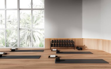 Beyaz ve ahşap duvarları, ahşap zemini ve gri yoga minderleri olan modern bir spor salonu. Spor anlayışı ve aktif yaşam tarzı. 3d oluşturma