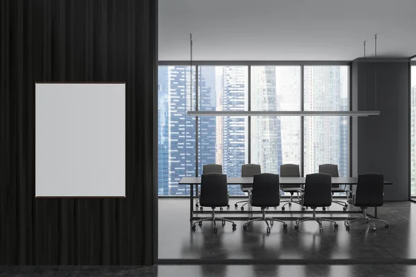 Side view on dark office interior with empty white poster, panoramic windows with Singapore city view, meeting board with armchairs, concrete floor. Concept of place for meeting. Mock up. 3d rendering