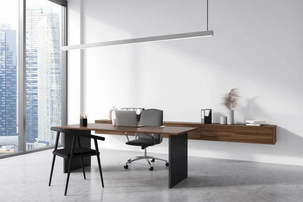 Dark consulting interior with laptop on work desk, side view, grey concrete floor. Floating sideboard with documents and decoration, panoramic window on city view. 3D rendering