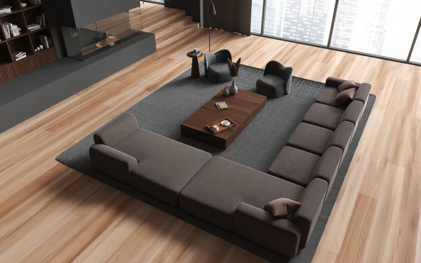 Top view of home living room interior with sofa and armchairs, coffee table and fireplace, carpet on hardwood floor. Shelf with decoration and panoramic window on skyscrapers. 3D rendering