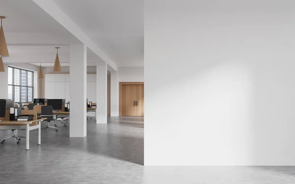 stock image Interior of modern open space office with white walls, concrete floor, row of computer tables and mock up wall on the right. 3d rendering