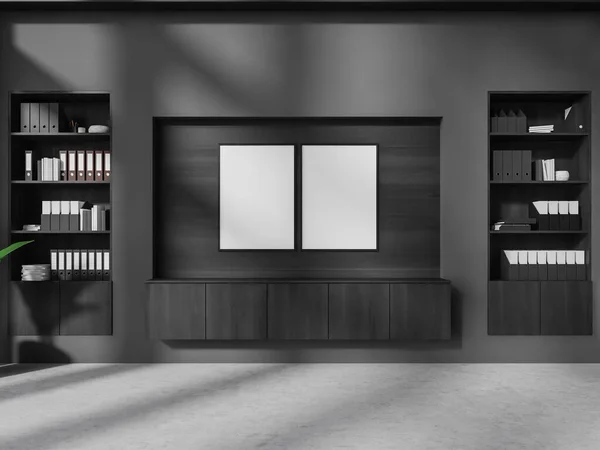 有灰色和木制墙壁的时尚办公室的内部 混凝土地面 橱柜上方有两个垂直的模拟海报和书架 3D渲染 — 图库照片