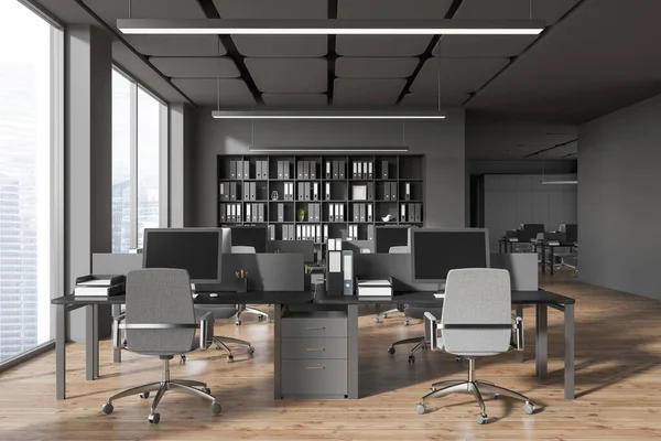 stock image Interior of stylish open space office with gray walls, wooden floor, rows of wooden and gray computer tables and bookcases with folders. 3d rendering