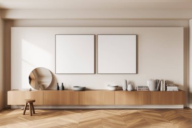 Bej sergi odası. Uzun ahşap çekmecesi, kitaplarla süslenmiş sanat dekorasyonu, ahşap taburesi var. Sıraya dizilmiş iki tane tuval posteri. 3B görüntüleme