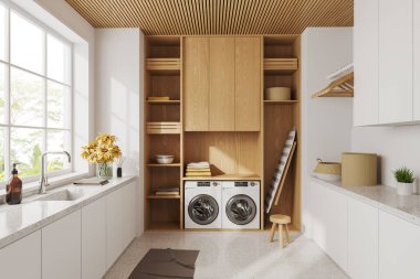 Çamaşır odası, lavabo, çamaşır makinesi ve rafta havluyla ütü masası olan, beton zemini olan beyaz, modern tasarım bir daire. Tropik bölgelerde panoramik pencere. 3B görüntüleme