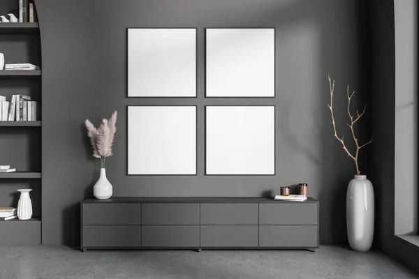 Dark gallery room interior with sideboard and shelf with art decoration, vase with branch in the corner on grey concrete floor. Four square mock up posters in row. 3D rendering
