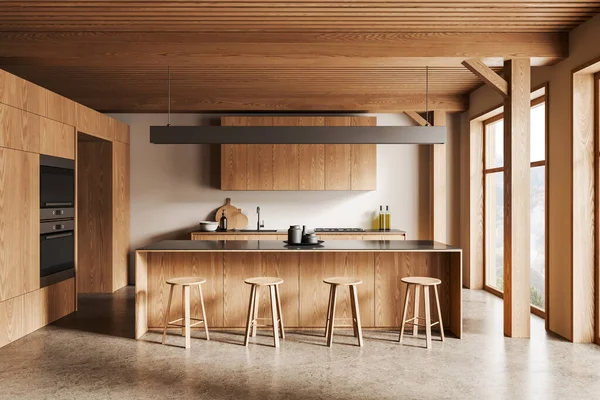 Interior of modern kitchen with white walls, concrete floor, wooden cabinets with built in cooker and sink and wooden bar counter with stools. 3d rendering