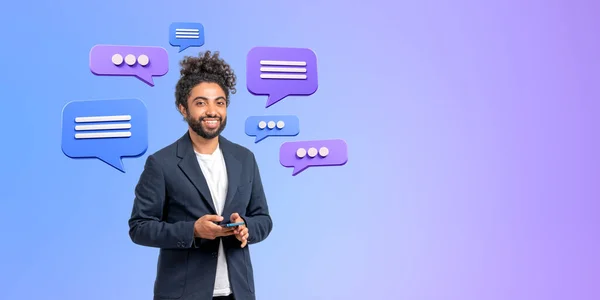 スマートフォンを持っている中東のビジネスマンの笑顔 紫色の背景にテキストメッセージの泡 ソーシャルメディア ビジネス会話 オンラインネットワークの概念 — ストック写真