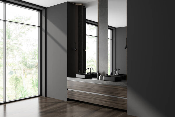 Corner view on dark bathroom interior with two mirrors, panoramic window with countryside view, sinks, grey walls, shelves under faucet, liquid soap, oak wooden hardwood floor. 3d rendering