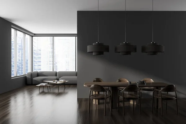 Dark living room interior with dining table with chairs on hardwood floor, sofa and coffee table in the corner. Panoramic window on city skyscrapers. 3D rendering