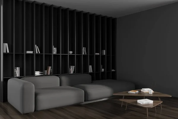 Dark living room interior with sofa and coffee table, side view, hardwood floor. Long shelf with books and decoration. Mockup empty wall. 3D rendering