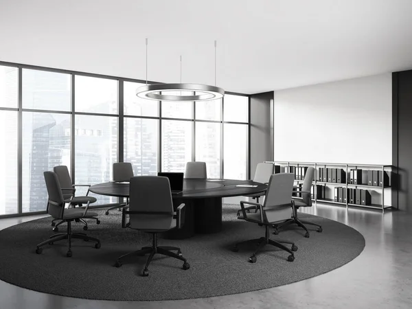 stock image Interior of stylish meeting room with white and gray walls, concrete floor, round conference table with gray chairs and cabinet with folders. 3d rendering