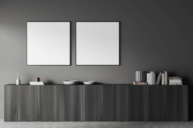 İçinde siyah ahşap şifonyer ve rafında kitaplar olan sanat dekorasyonu olan karanlık bir galeri odası. İki tane kare poster. 3B görüntüleme