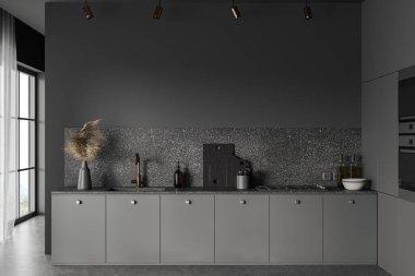 Gri duvarları, beton zemini ve pencerenin yanında duran lavabo ve fırının içine monte edilmiş rahat gri dolapları olan şık bir mutfak. 3d oluşturma