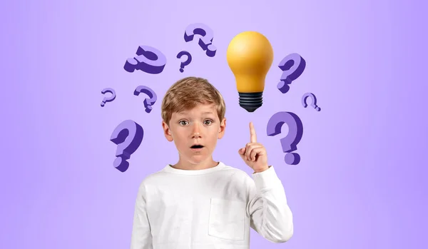 Portrait of smart schoolboy in casual clothes standing with open mouth pointing at light bulb and question marks over purple background. Concept of bright idea, education and curiosity