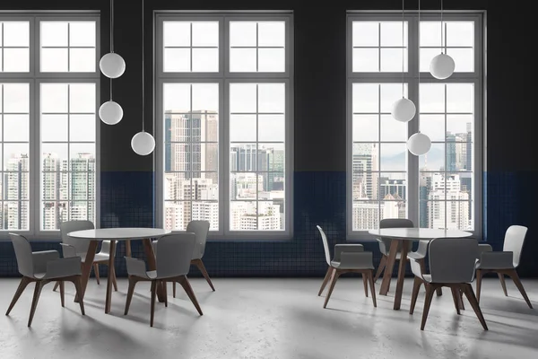 stock image Interior of stylish restaurant with gray and blue tiled walls, concrete floor, comfortable round tables with gray chairs and windows with cityscape. 3d rendering