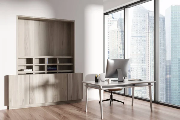 Stock image White office corner interior with desk and pc computer, side view. Wooden shelf with decoration and panoramic window on Singapore skyscrapers. 3D rendering