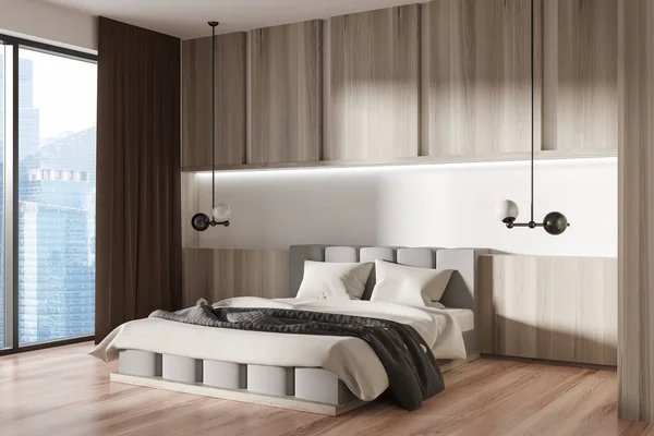stock image Wooden bedroom interior with bed and lamps, side view, hardwood floor. Hotel sleeping area with panoramic window on Singapore city view. 3D rendering