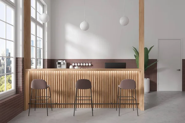 Interior of modern coffee shop with white and brown tiled walls, concrete floor, wooden bar counter with coffee machine behind it and brown stools. 3d rendering