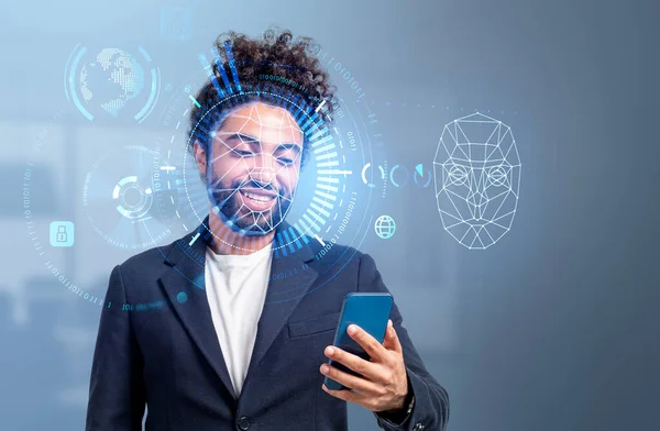 Stock image Smiling handsome middle eastern businessman wearing formal wear is taking selfie via smartphone. Hologram with face, pie diagram, virtual globe. Concept of facial recognition, biometric scanning