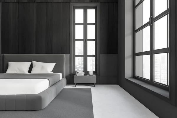 Dark bedroom interior bed and nightstand with decoration, carpet on grey concrete floor. Sleeping area and modern furniture. Panoramic window on skyscrapers. 3D rendering