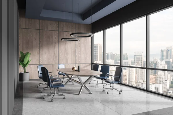 Interior of modern office board room with gray and wooden walls, stone floor, long conference table with blue chairs and panoramic window with cityscape. 3d rendering