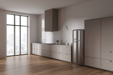 Modern mutfağın köşesinde beyaz duvarlar, ahşap zemin, fırında yapılmış bej dolaplar ve büyük pencerenin yanında duran lavabo ve rahat buzdolabı. 3d oluşturma