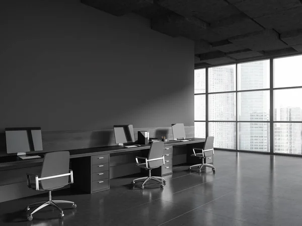Comfortable workplace in minimalistic industrial style office with gray walls, tiled floor and row of computer tables standing along copy space wall with gray chairs. 3d rendering