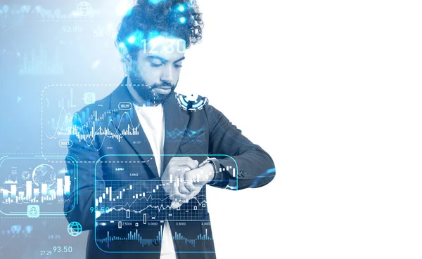 Middle eastern businessman with pensive look looking at his smart watch, forex diagrams with numbers and candlesticks. Financial hologram with analysis. Concept of trading. Copy space