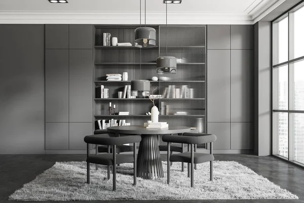 Dark living room interior with dining table and chairs, carpet on grey concrete floor. Stylish shelf with decoration. Panoramic window on skyscrapers. 3D rendering