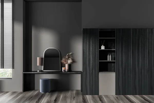 Dark bedroom interior with dressing table, seat and mirror with minimalist decoration on hardwood floor. Black wooden shelf with panoramic window on tropics view. 3D rendering