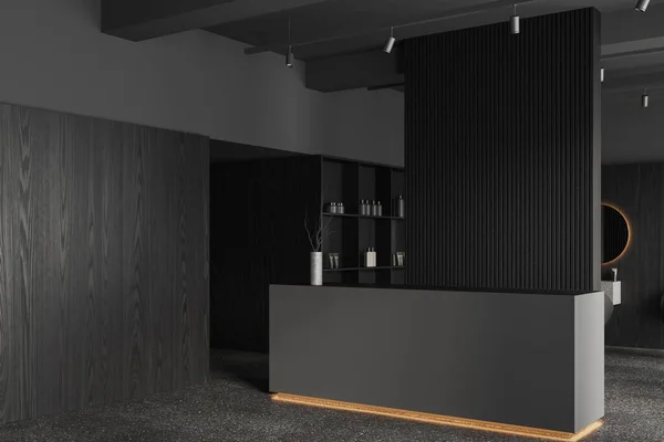 Comfortable gray reception counter standing in stylish beauty salon with gray and dark wooden walls, concrete floor and shelves with beauty products. 3d rendering
