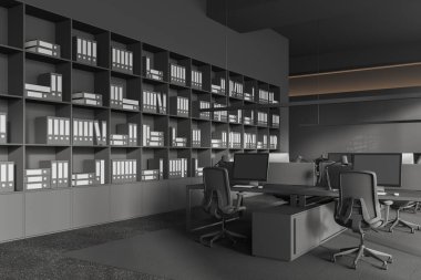 Çalışma odasının içinde koltuklar ve masa başında bilgisayar, gri beton zeminde yan manzara halısı var. Ofis köşesi ve raflar klasörlerle dolu. 3B görüntüleme