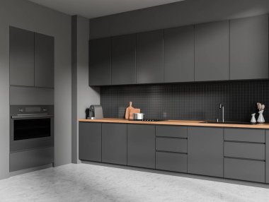 Mutfak içi karanlık, güvertede mutfak gereçleri var. Yan tarafı gri beton zemin. Minimalist aletler ve fırın monte edilmiş yemek köşesi. 3B görüntüleme