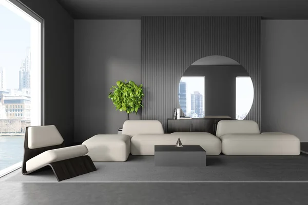 Front view on dark living room interior with sofa, armchair, coffee table, grey wall, round mirror, concrete floor, panoramic window with skyscrapers view. Concept of minimalist design. 3d rendering
