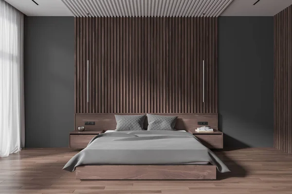 Dark home bedroom interior with bed and grey bed linen, nightstand with decoration, hardwood floor. Cozy sleeping room with minimalist design and tulle on window. 3D rendering