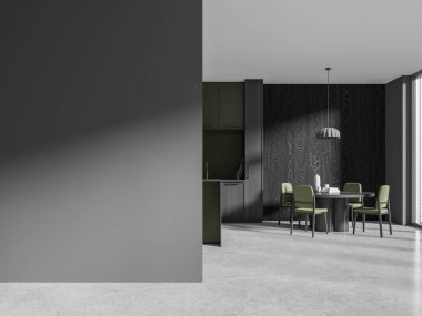 Gri ve koyu ahşap duvarları, beton zemini, gri ve yeşil dolapları, sandalyeli yuvarlak yemek masası ve solunda duvar maketi olan şık mutfağın içi. 3d oluşturma