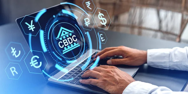 Man hands typing in laptop, side view. CBDC hud hologram with diverse glowing currency icons, virtual screen. Concept of blockchain, money trade and crypto exchange