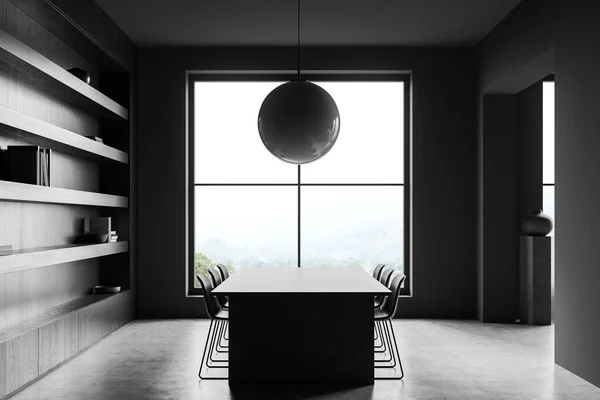 Interior of stylish dining room with gray walls, concrete floor, long dining table with chairs standing near window with mountain view and dark wooden bookcase. 3d rendering