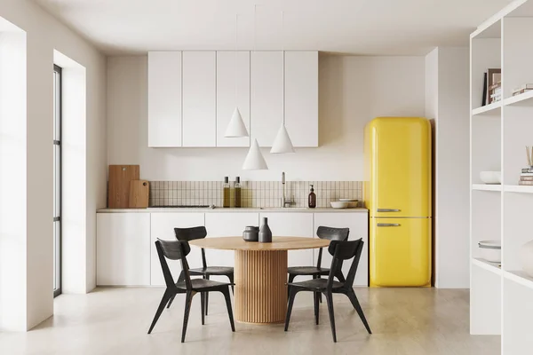 Interior of modern kitchen with white walls, concrete floor, white cabinets and cupboards, yellow refrigerator and round dining table with chairs. 3d rendering