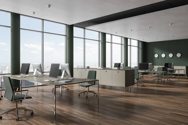 Interior of stylish open space office with green walls, wooden floor, row of beige computer desks with green chairs and clocks showing world time. 3d rendering